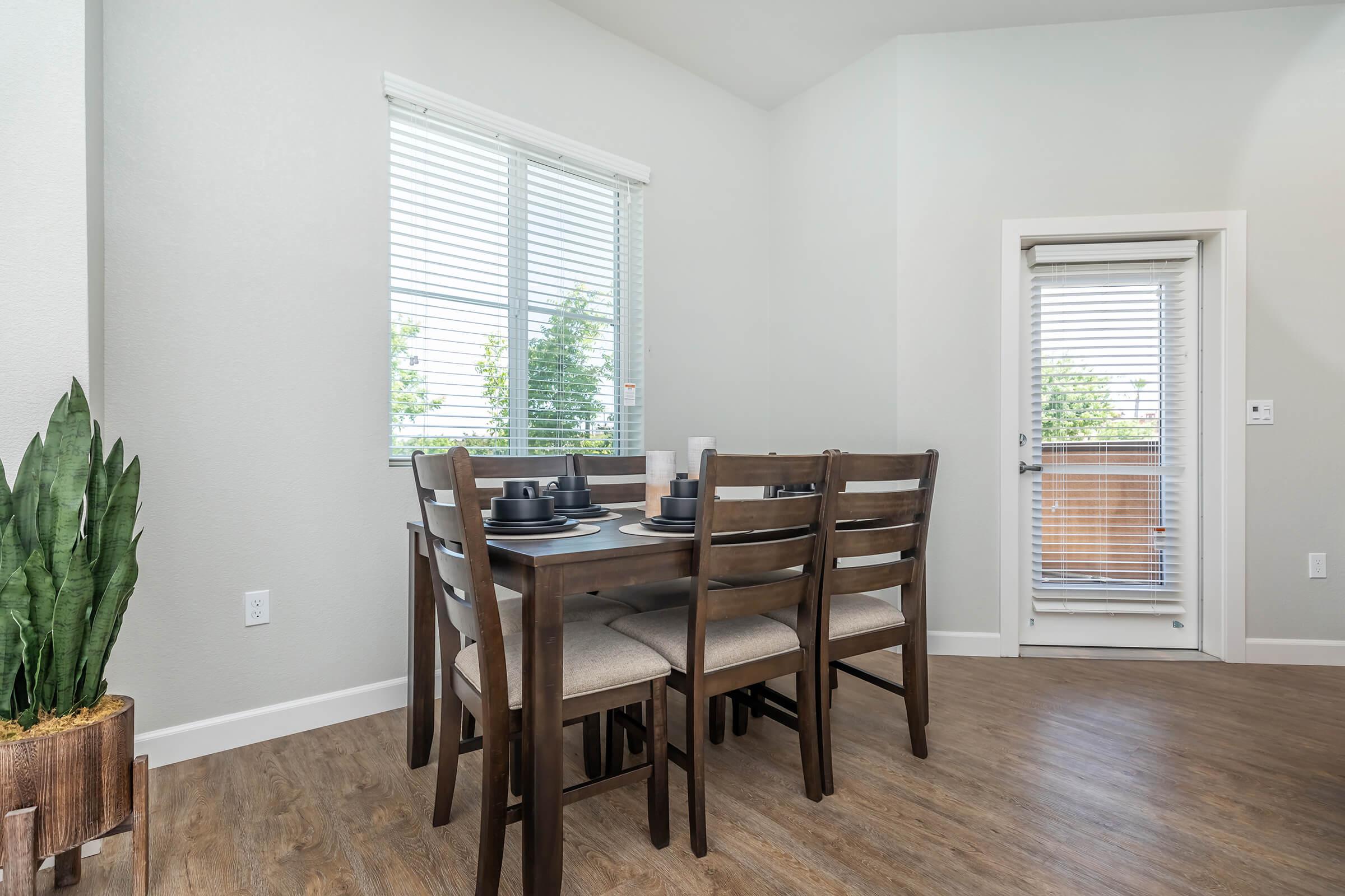 a dining room table in front of a window