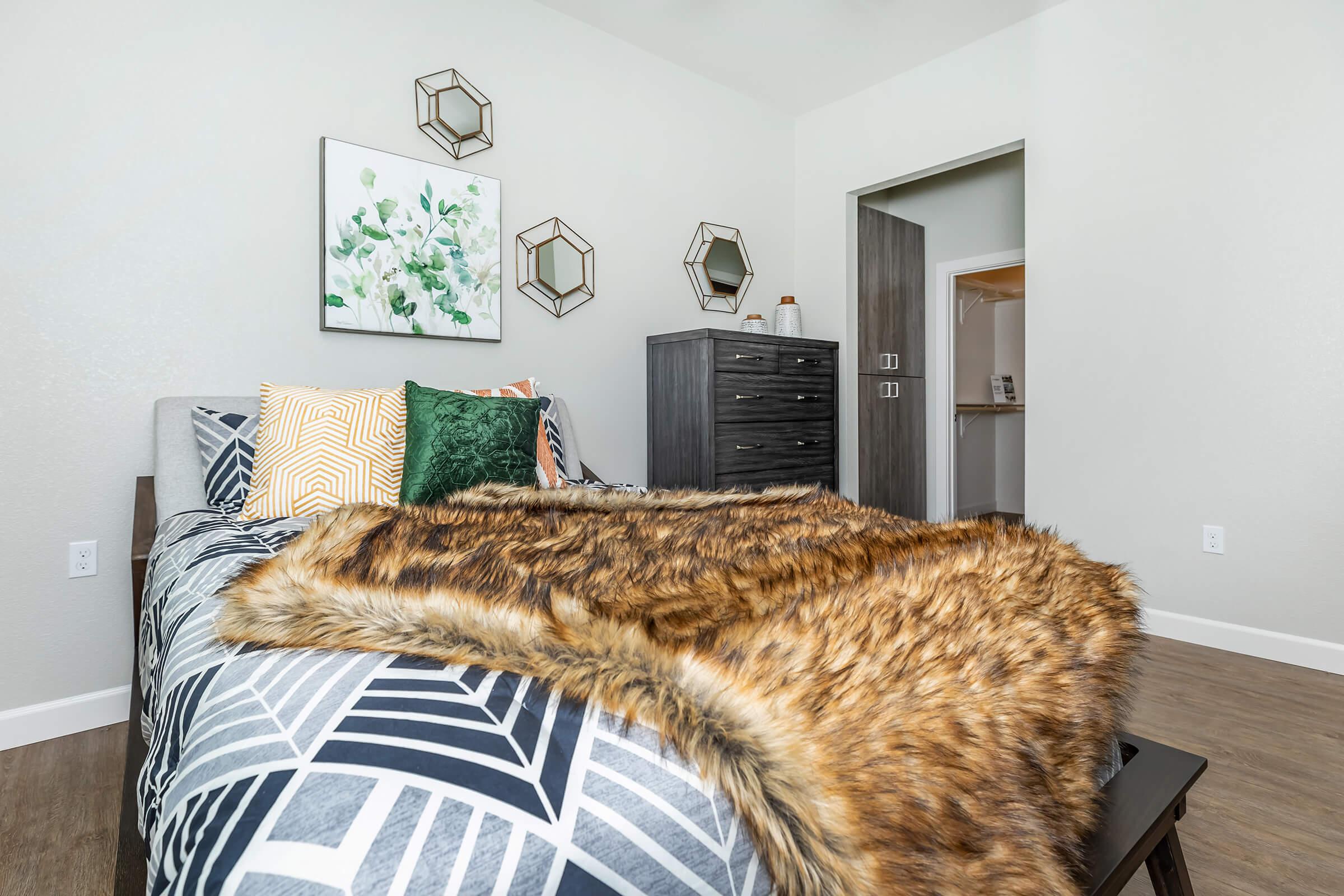 a cat sitting on top of a bed