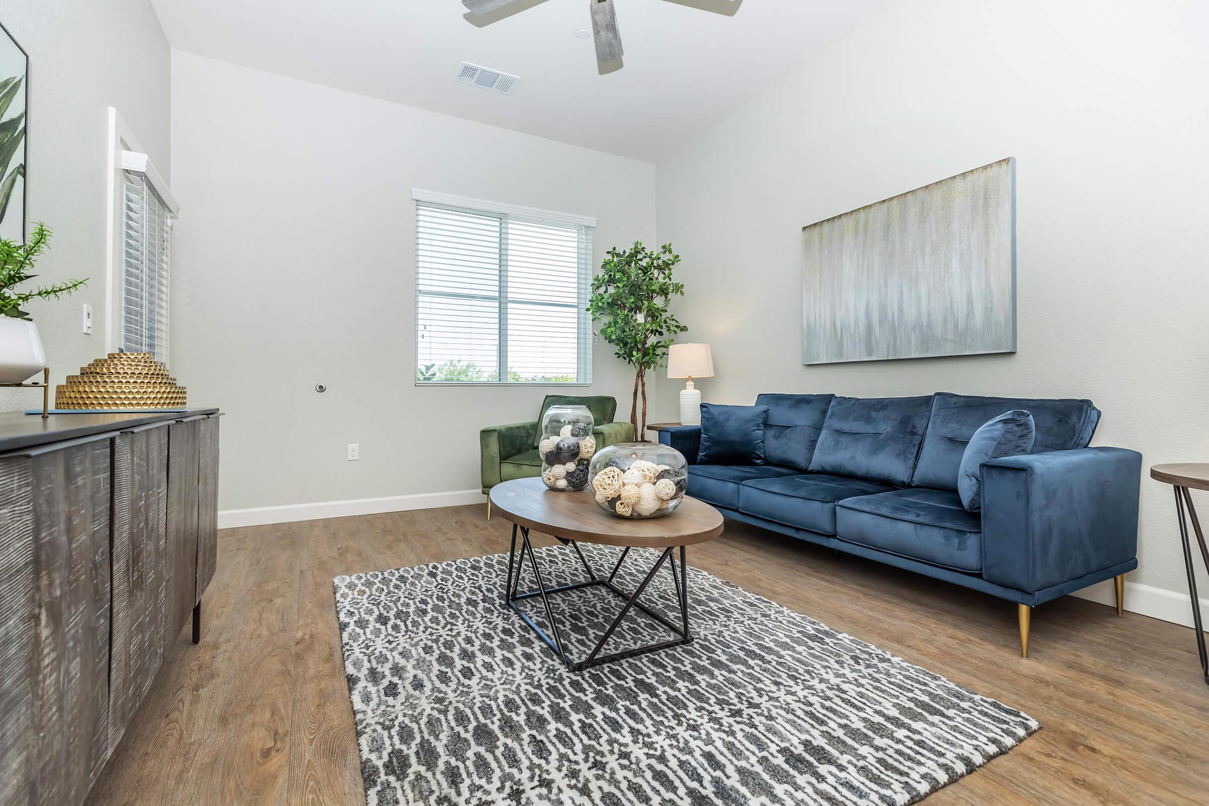 a living room filled with furniture and a large window