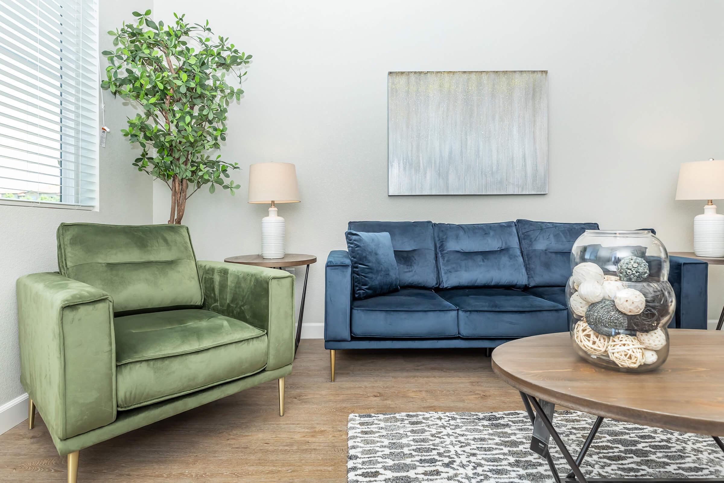 a living room filled with furniture and a lamp