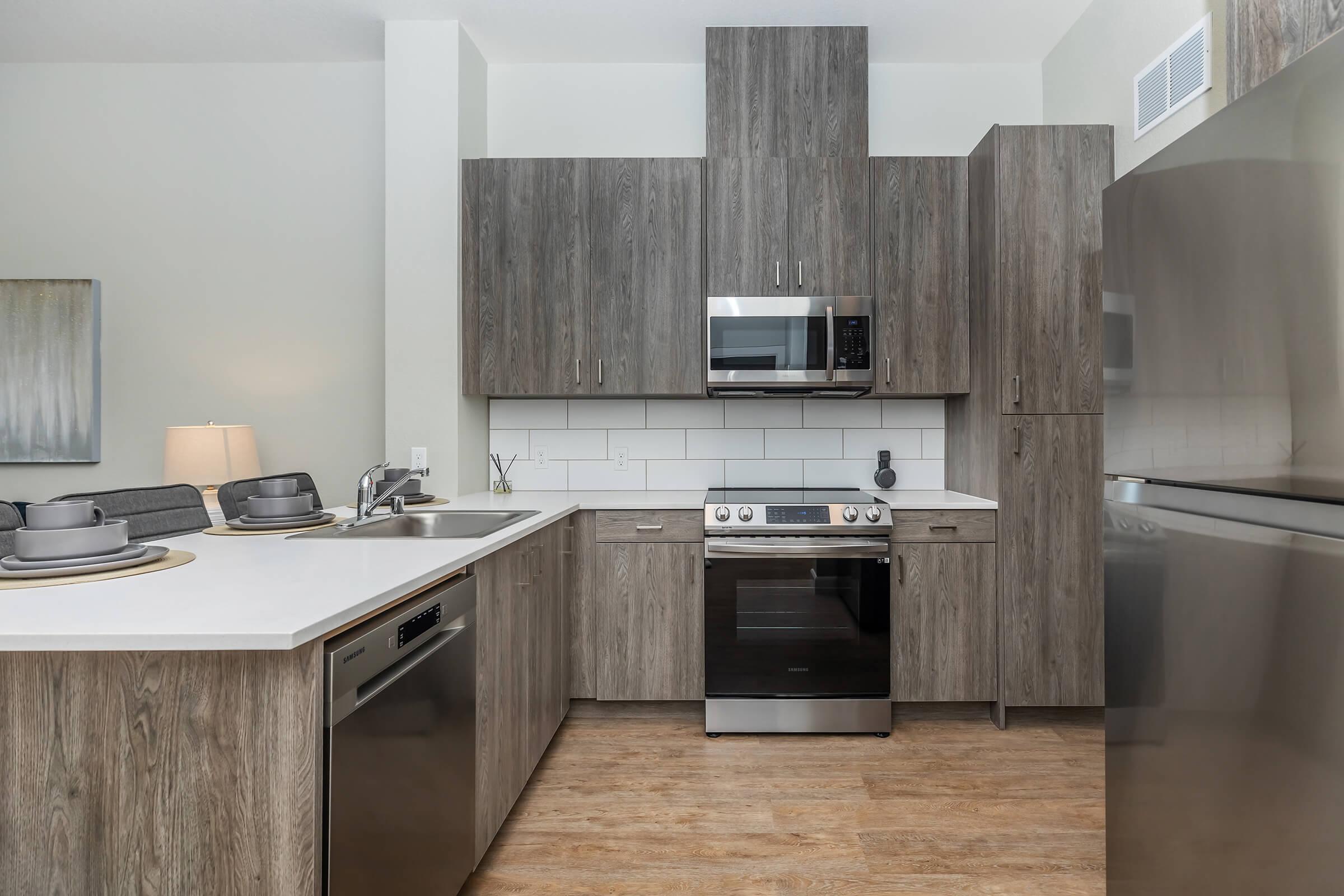 a kitchen with stainless steel appliances and wooden cabinets