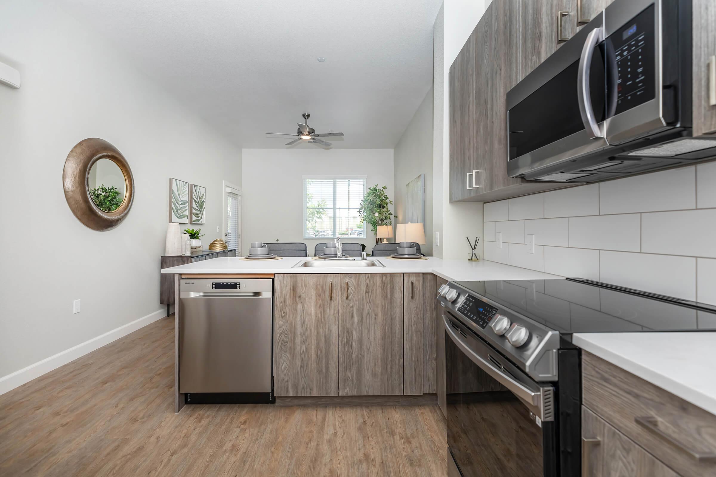 a modern kitchen with stainless steel appliances and wooden cabinets