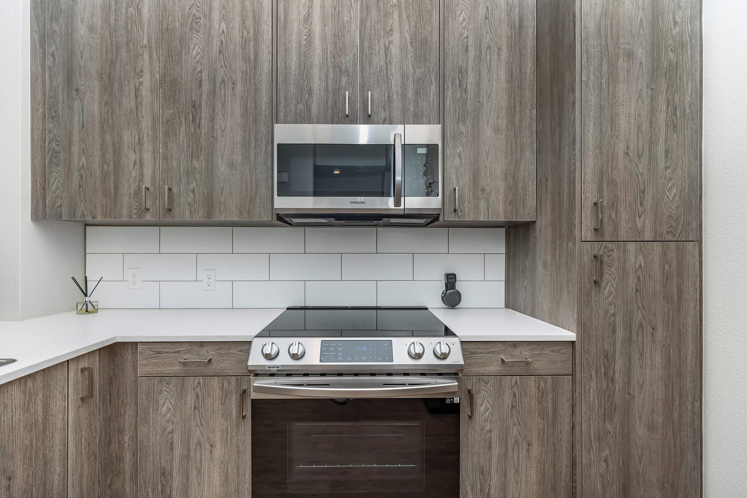 a microwave oven sitting on top of a wooden cabinet