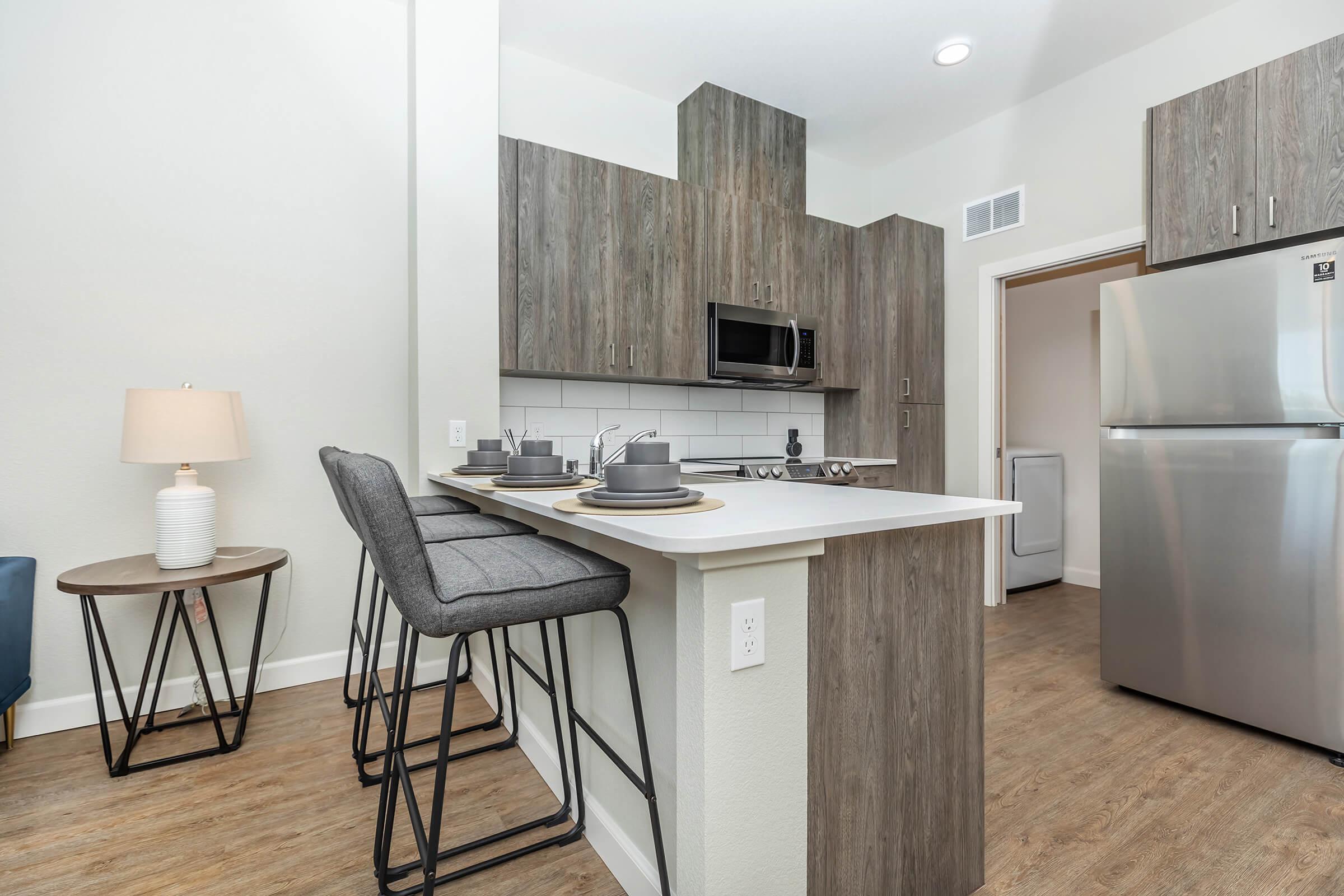 a kitchen with a refrigerator and table in a room