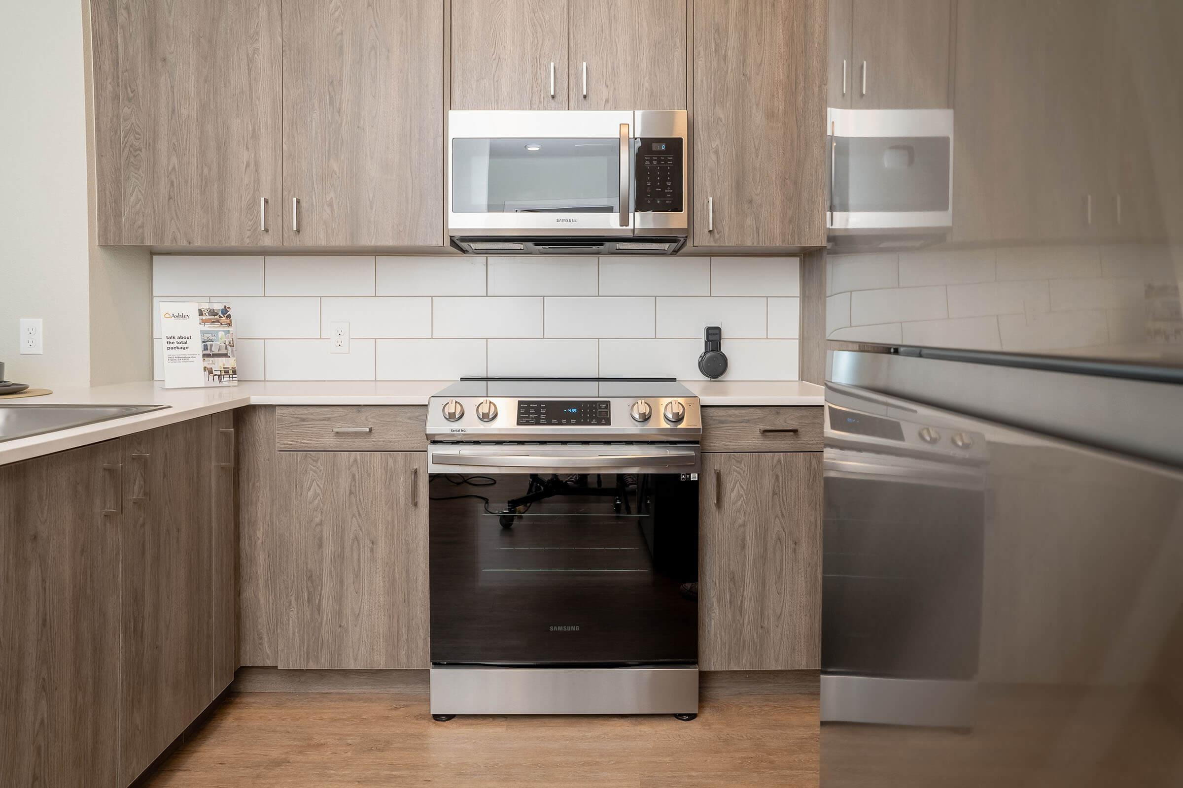 a stove top oven sitting inside of a kitchen