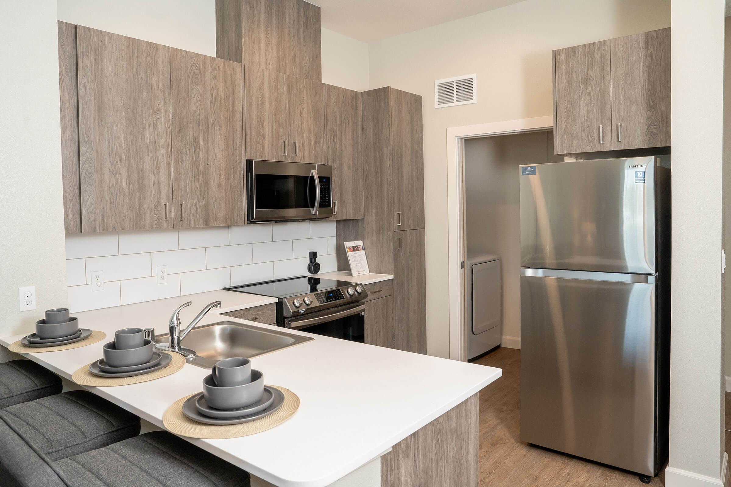 a kitchen with stainless steel appliances and wooden cabinets