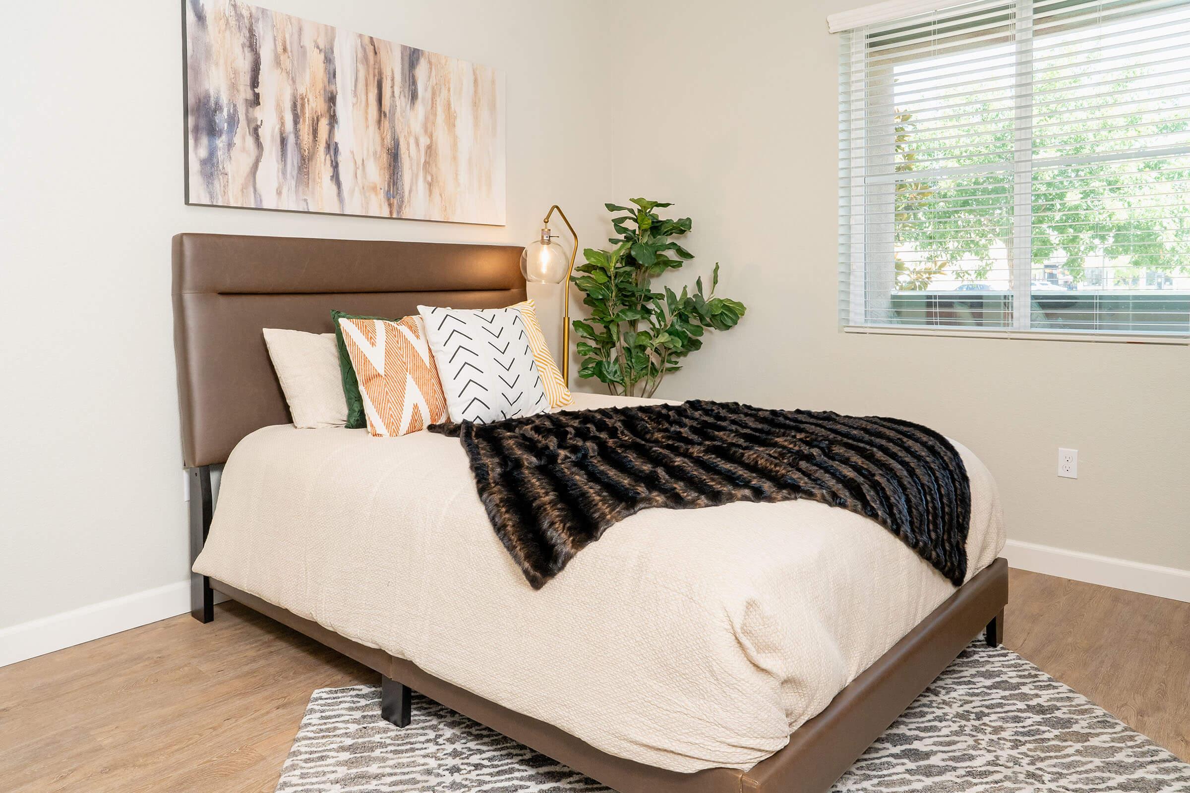 a living room with a bed and a window