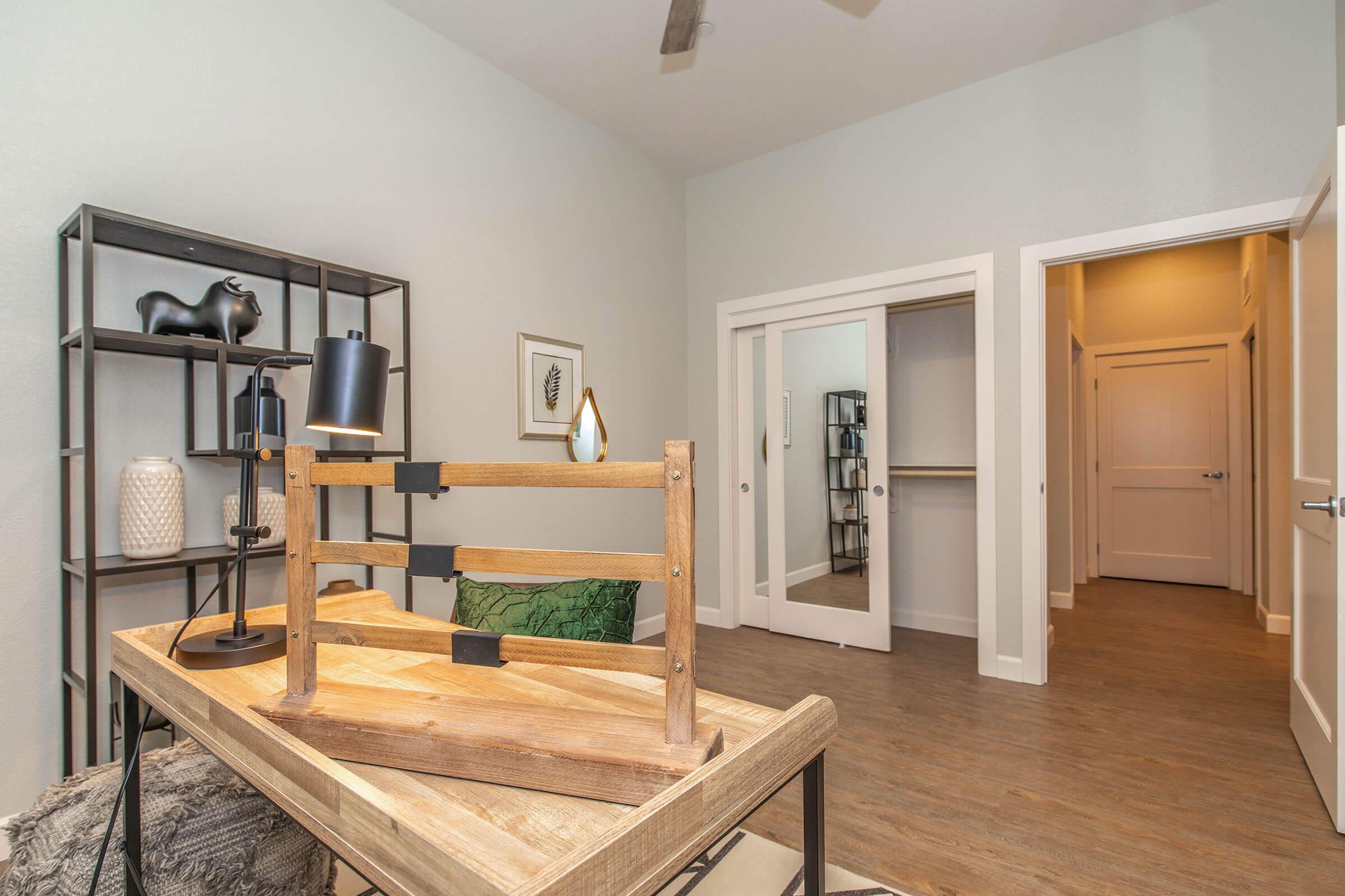 a kitchen with a sink and a mirror in a room