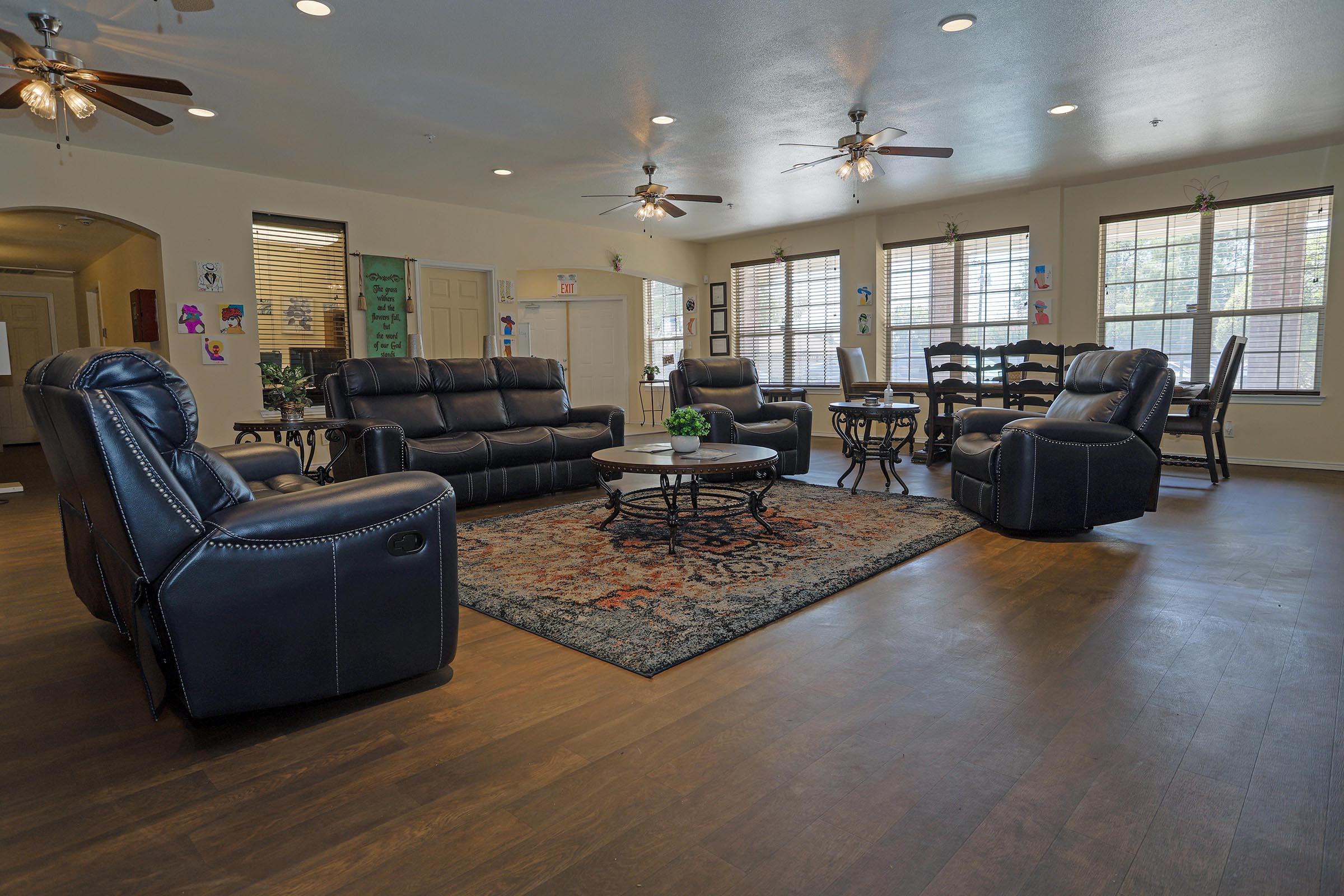 a living room filled with furniture and a large window