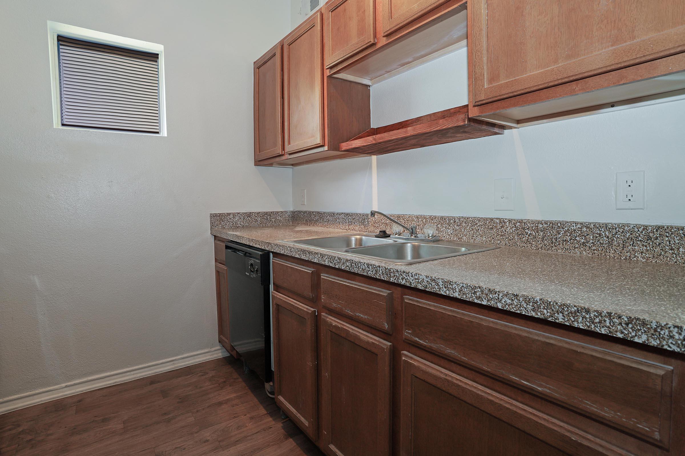 a kitchen with a sink and a mirror