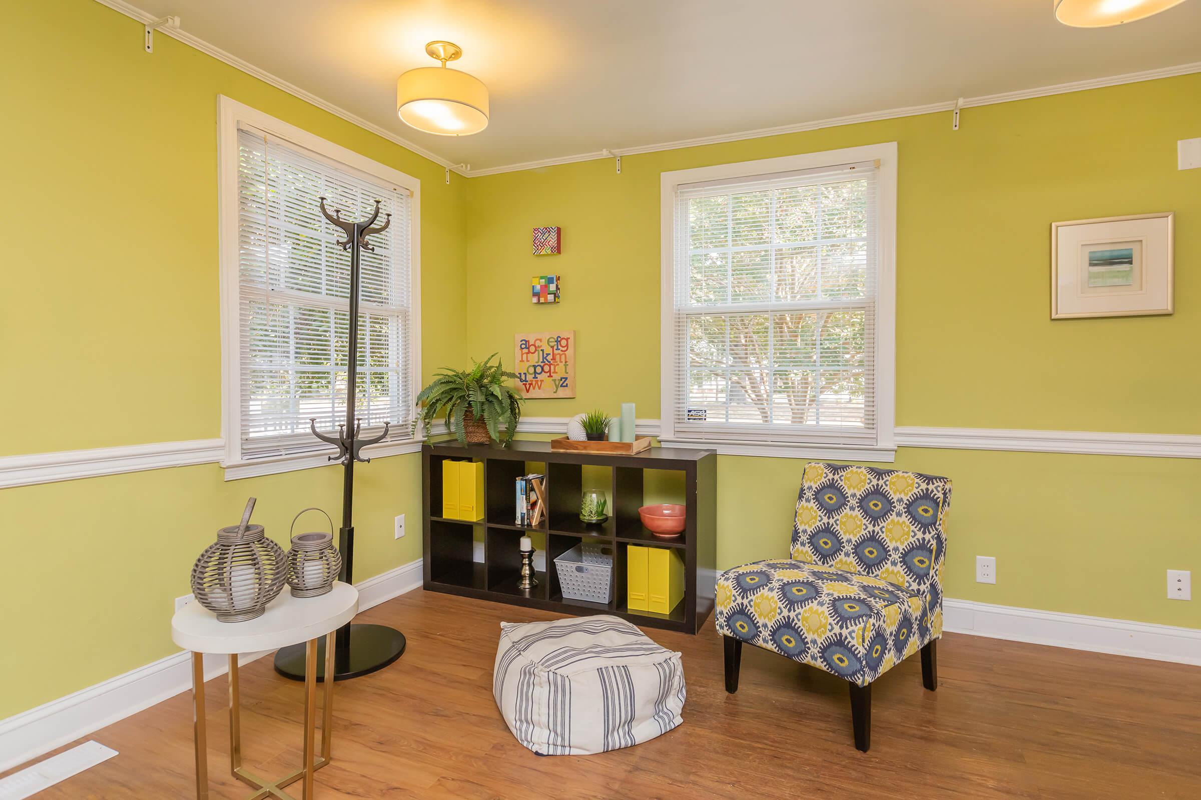 a living room with yellow walls