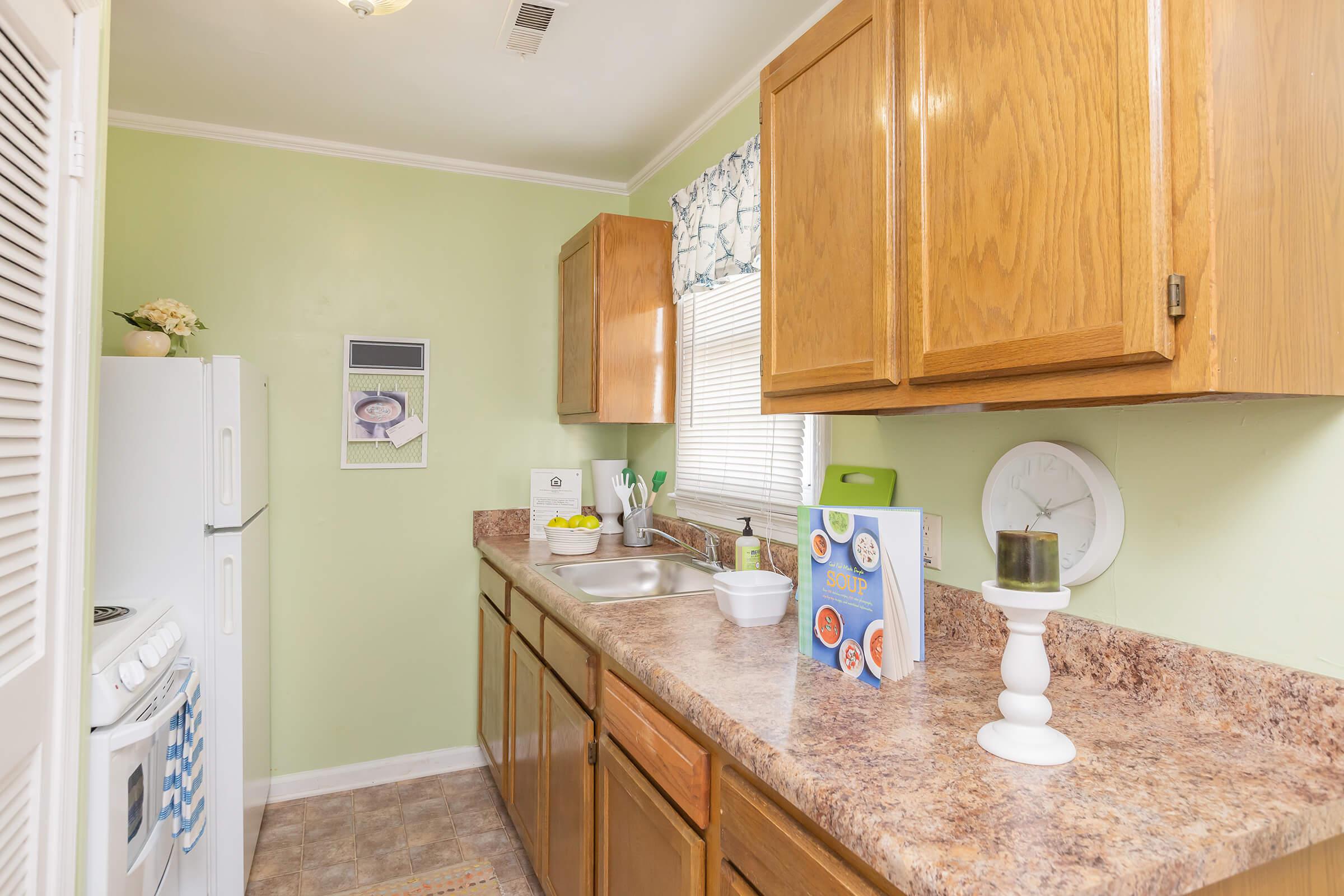 a kitchen with wooden cabinets and a sink
