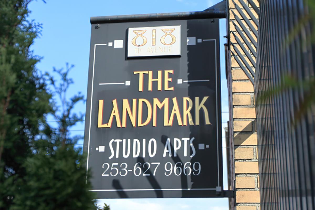 Sign for "The Landmark" studio apartments.