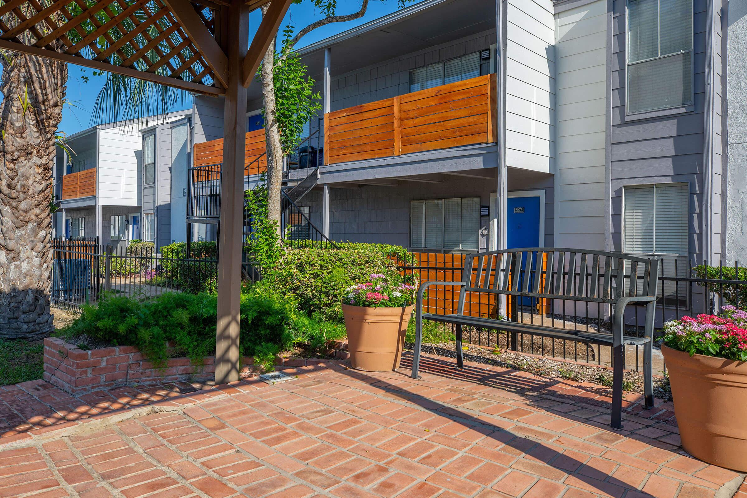 a bench in front of a brick building