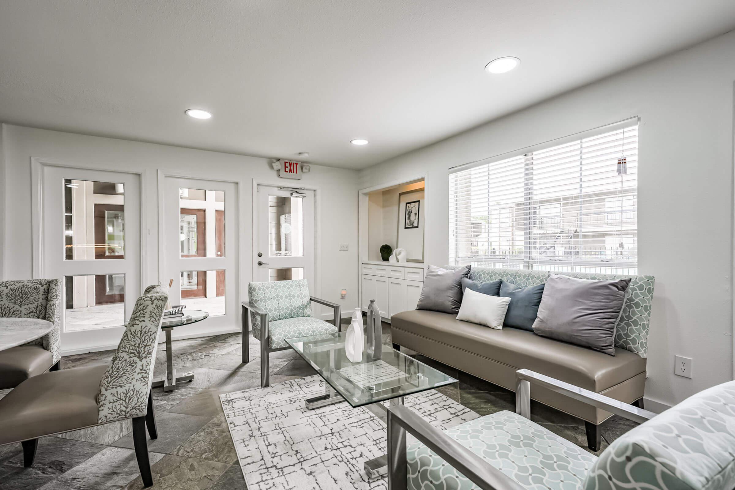 a living room filled with furniture and a large window