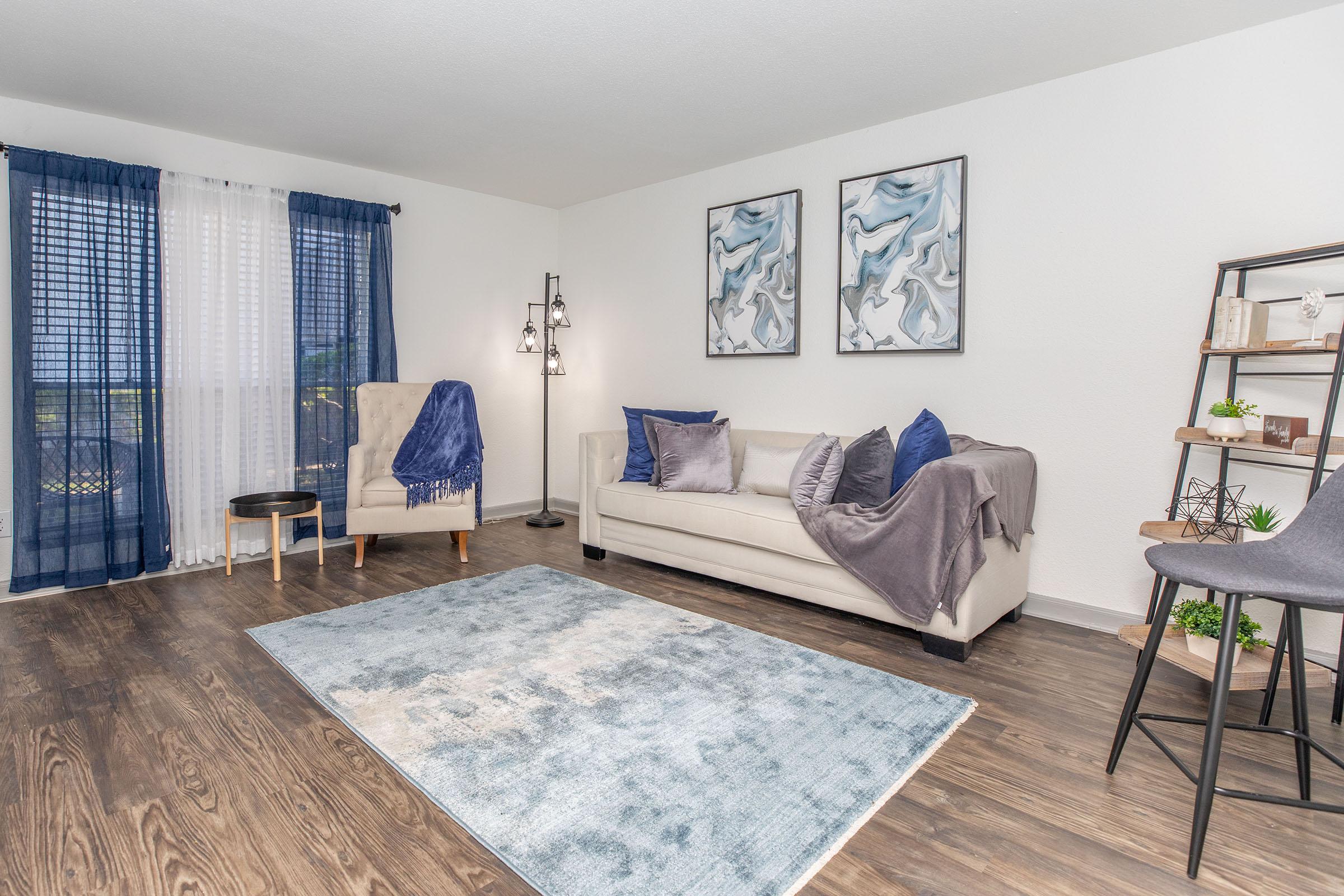 a living room filled with furniture and a rug