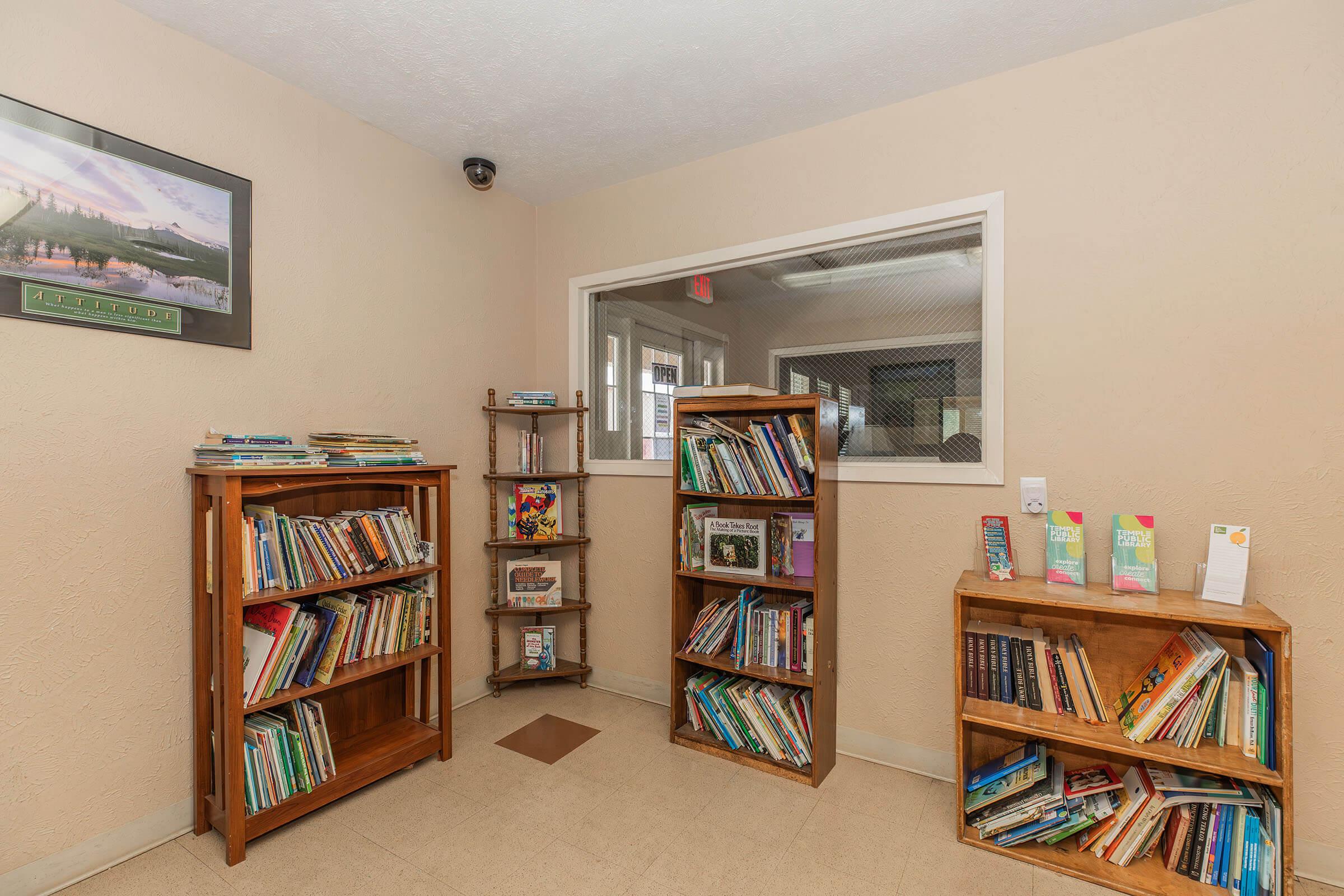 a living room filled with furniture and a book shelf