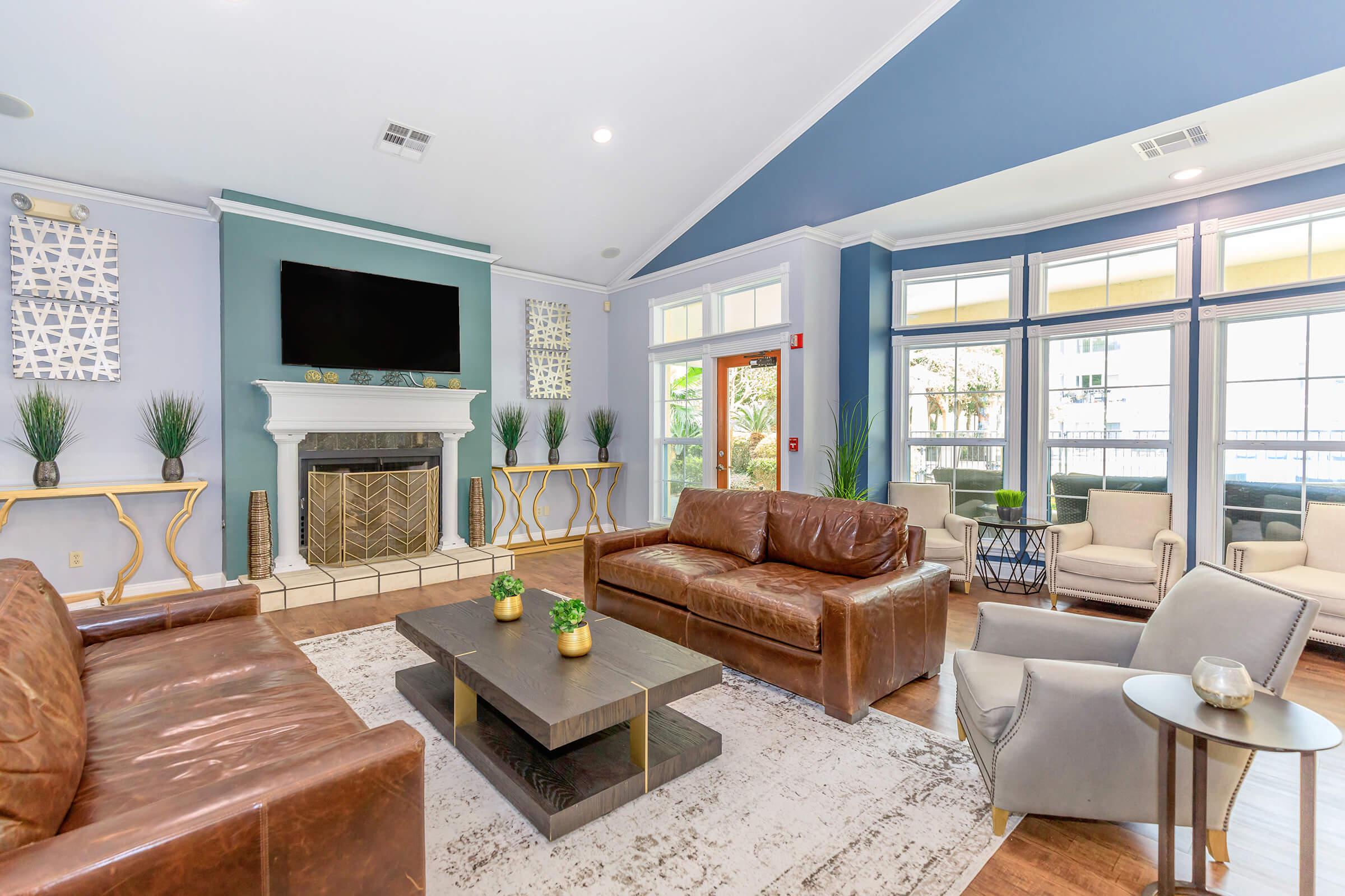 a living room filled with furniture and a large window