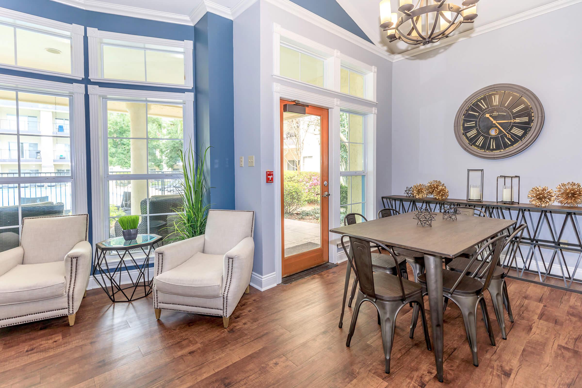 a living room filled with furniture and a large window