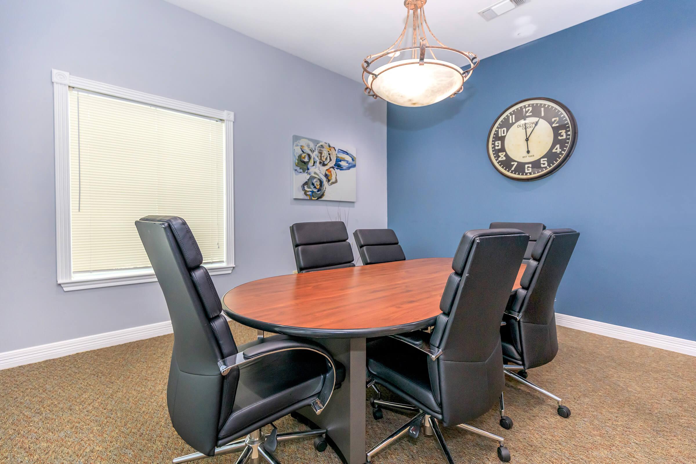 an office with a desk and chair in a room