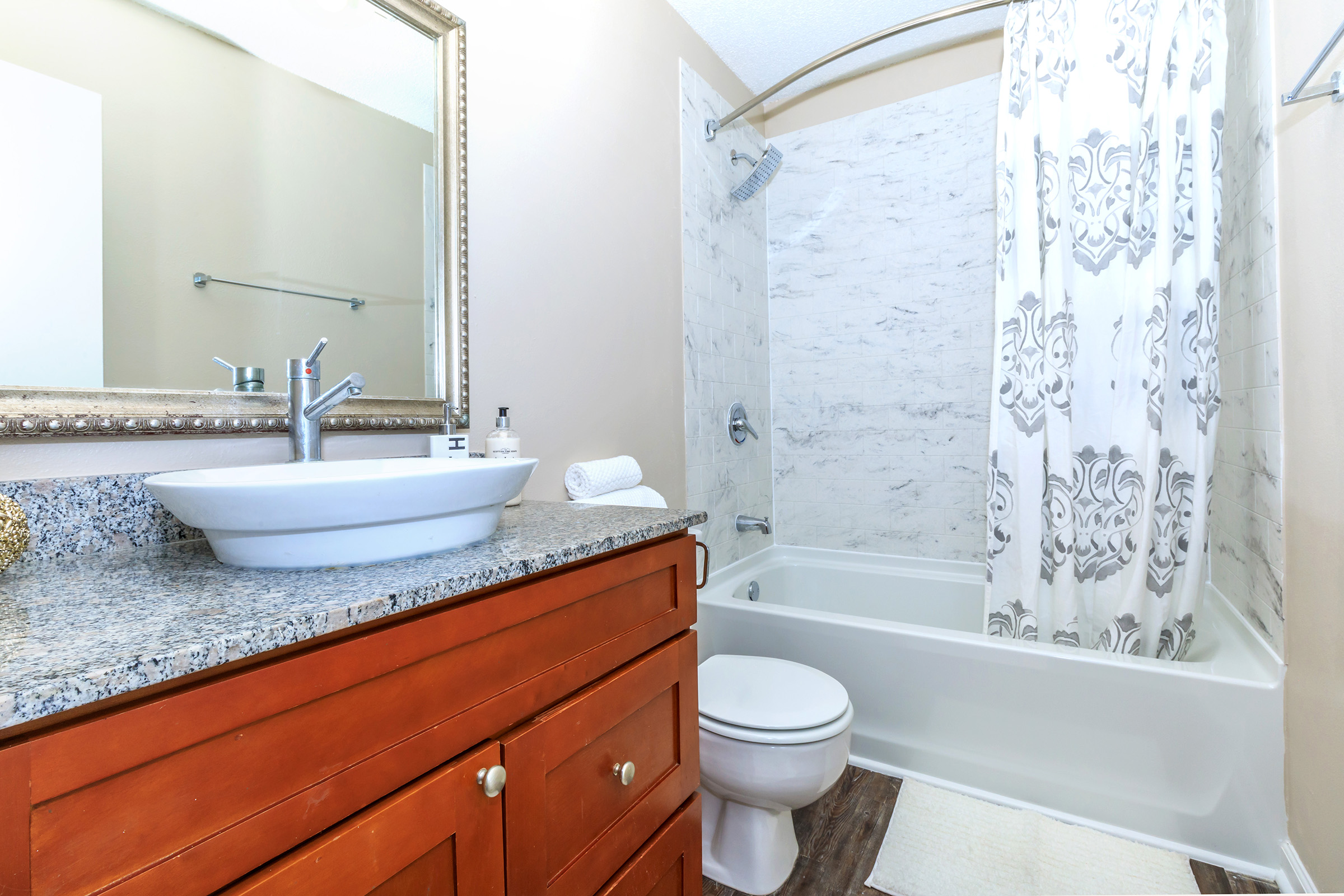 a shower that has a sink and a mirror