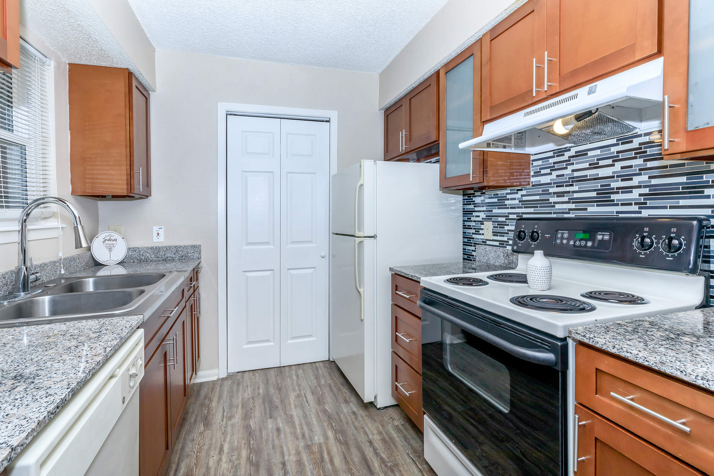 a modern kitchen with stainless steel appliances and wooden cabinets