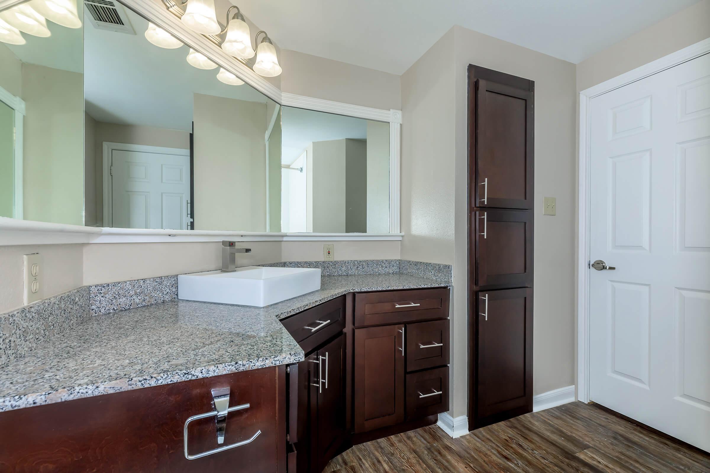 a kitchen with a sink and a mirror