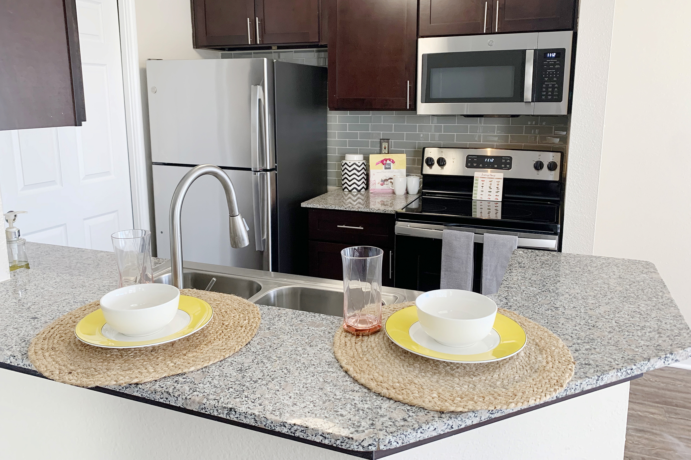 a kitchen with a sink and a cup of coffee