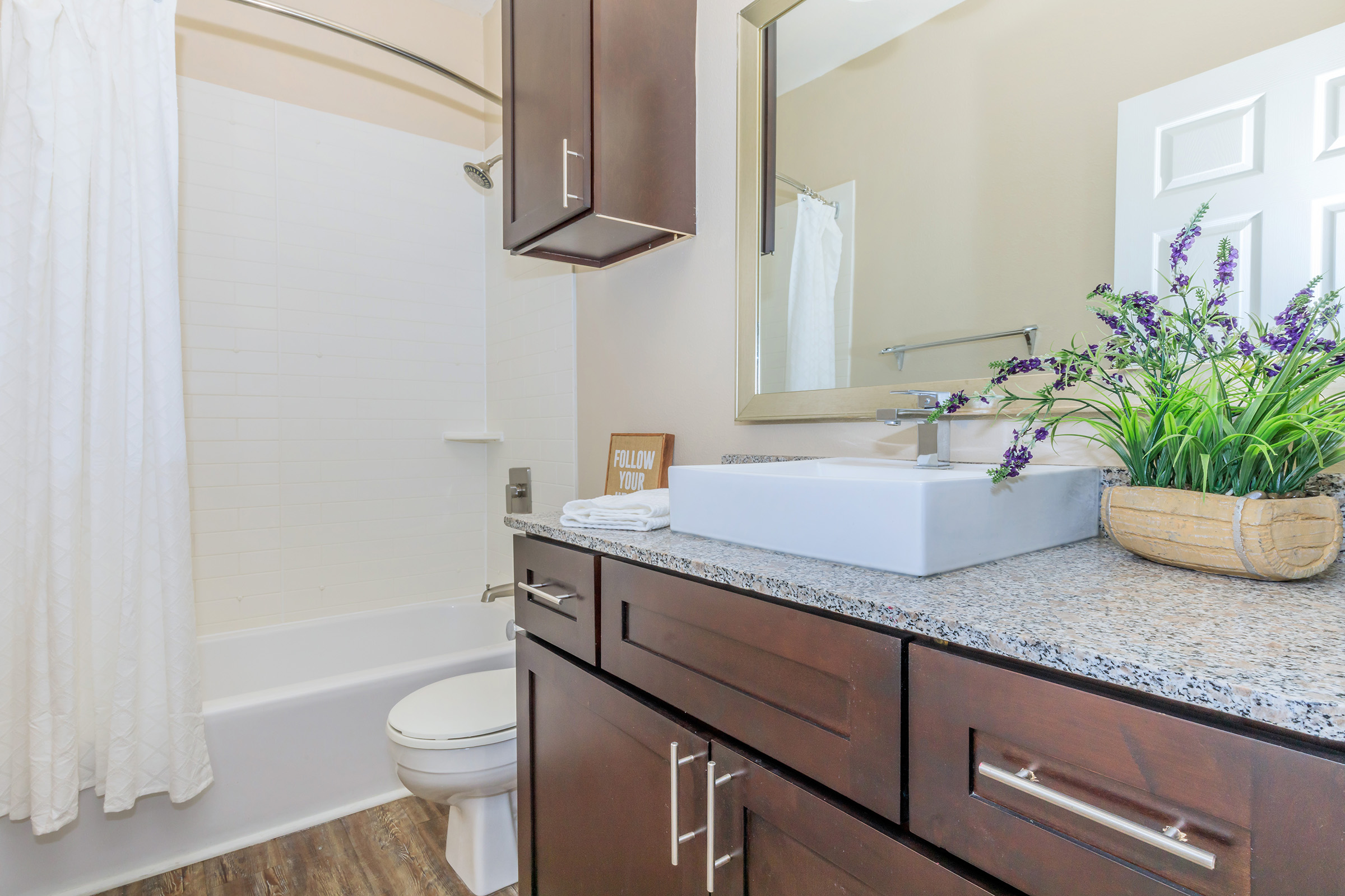 a kitchen with a sink and a mirror