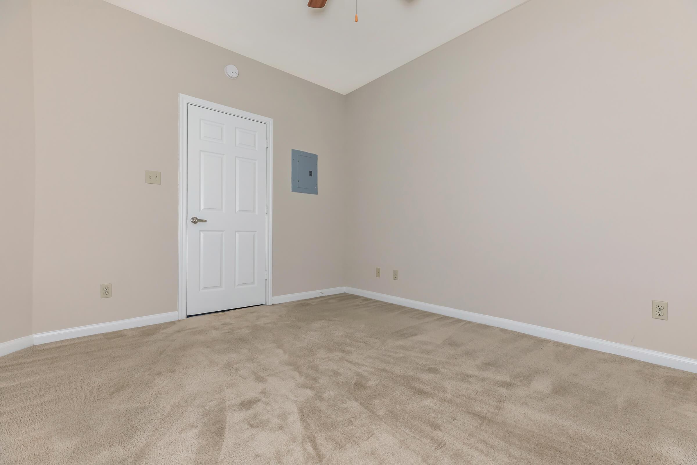 a bedroom with a bed in a room