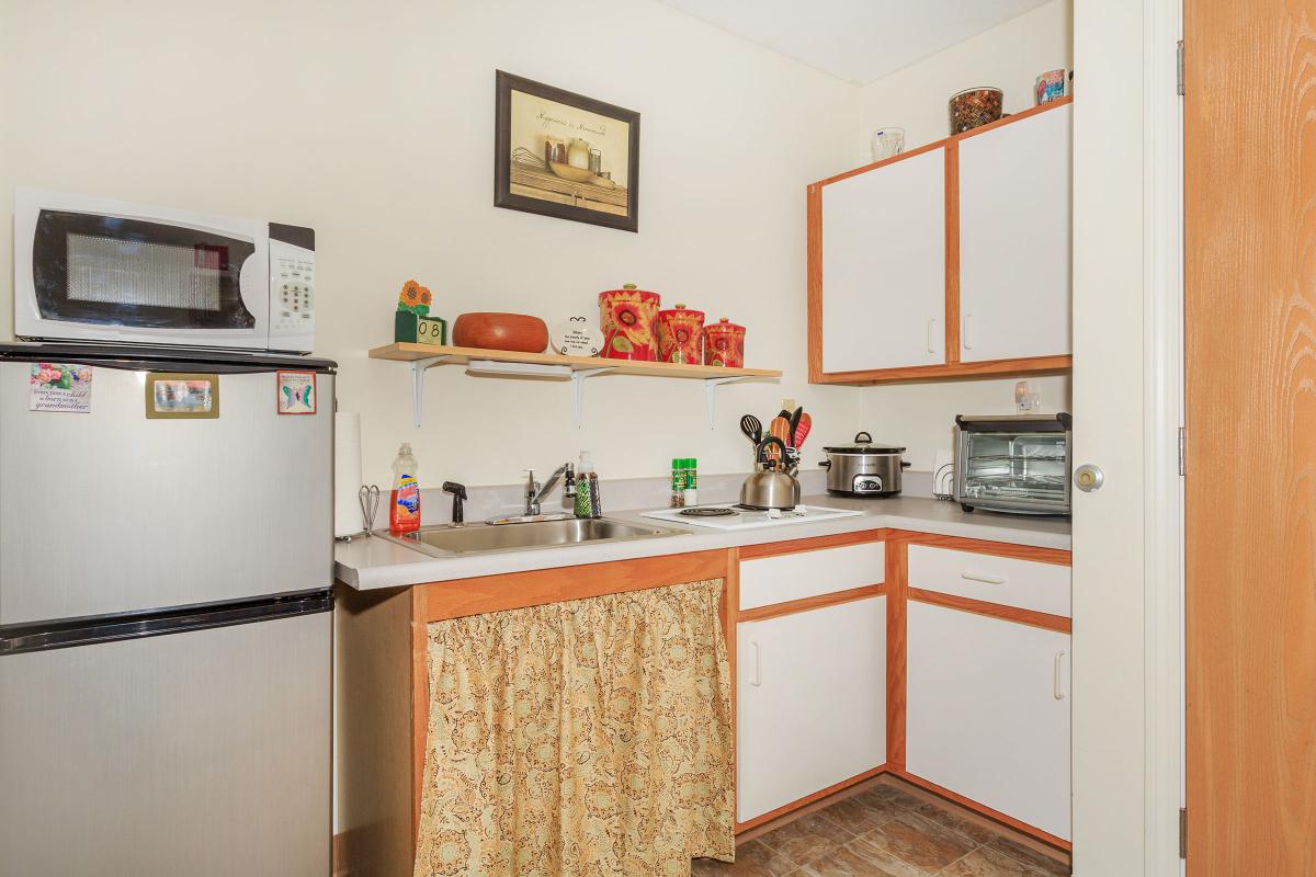 a white refrigerator freezer sitting inside of a kitchen