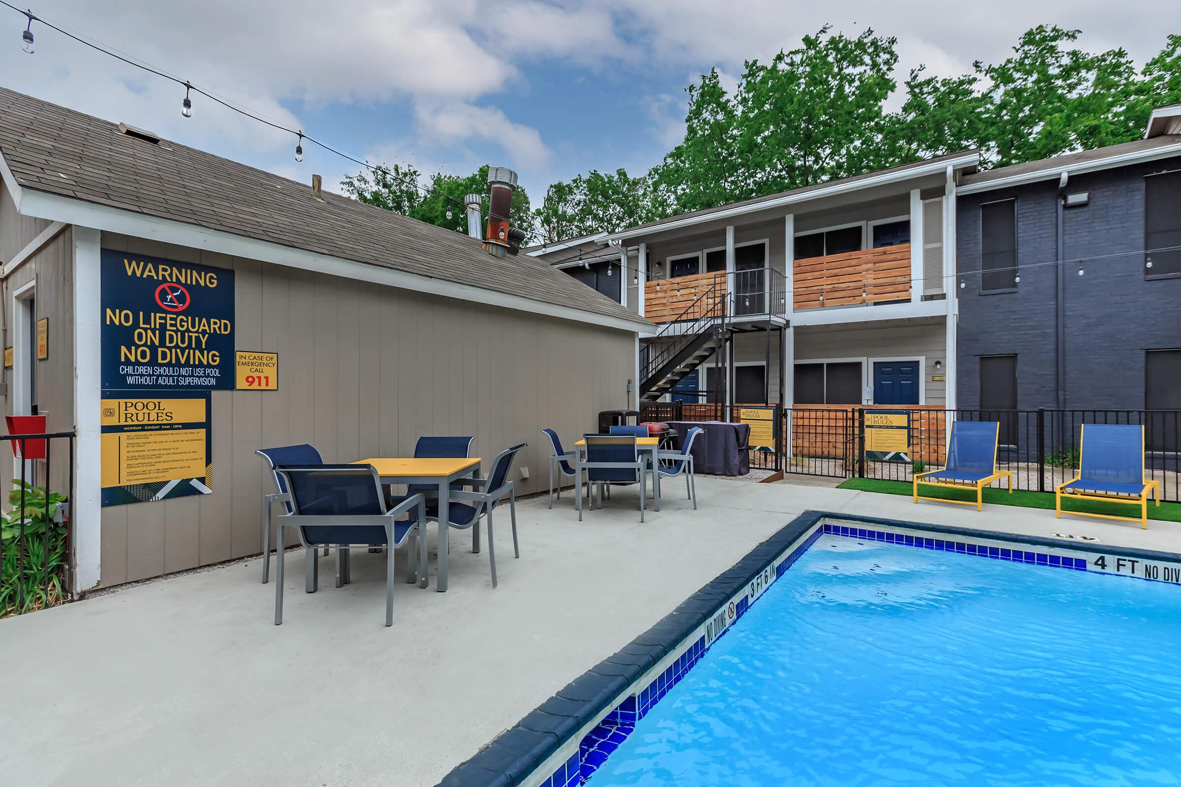 a house with a pool in front of a building