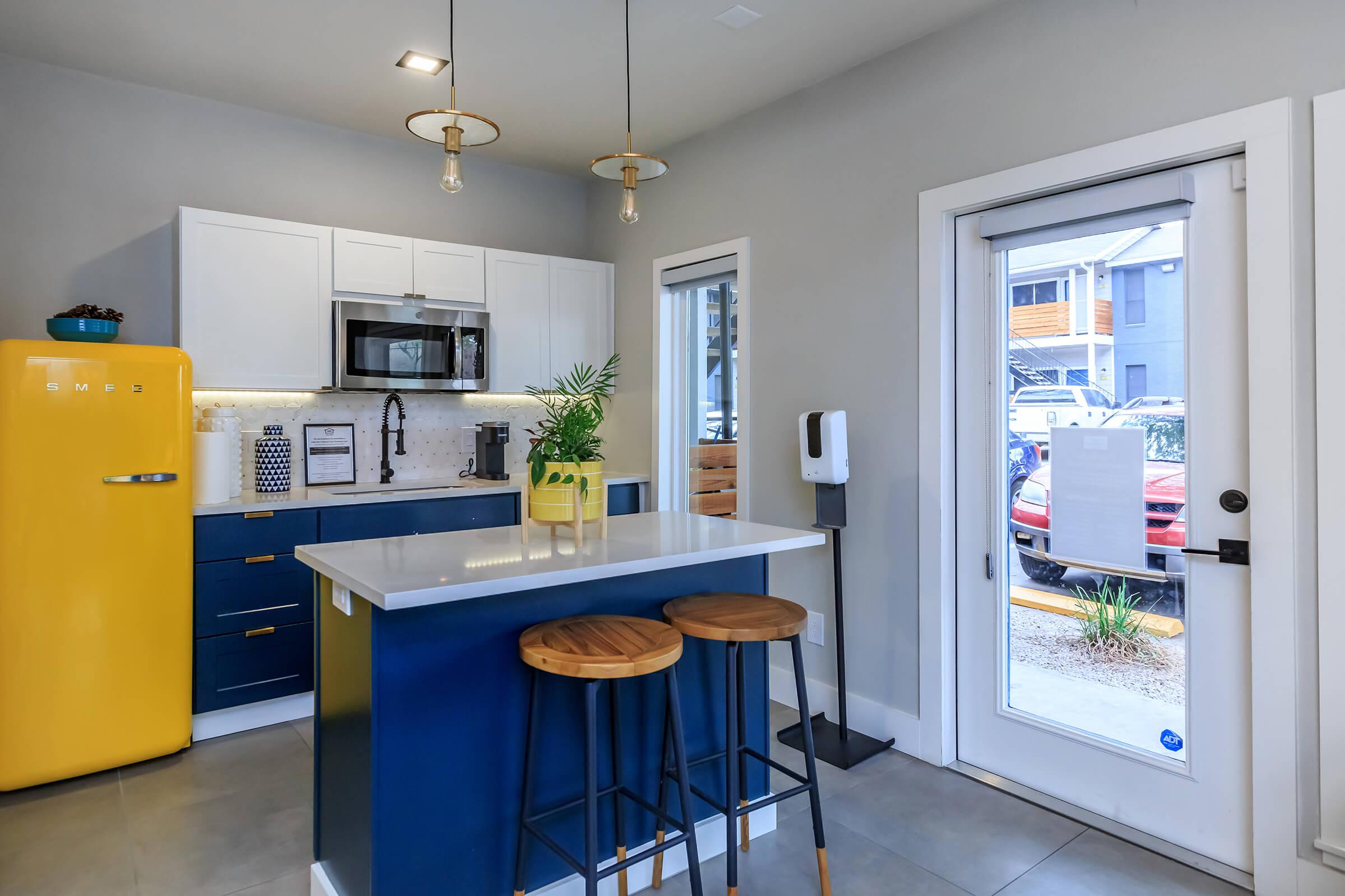 a kitchen with a refrigerator and table in a room