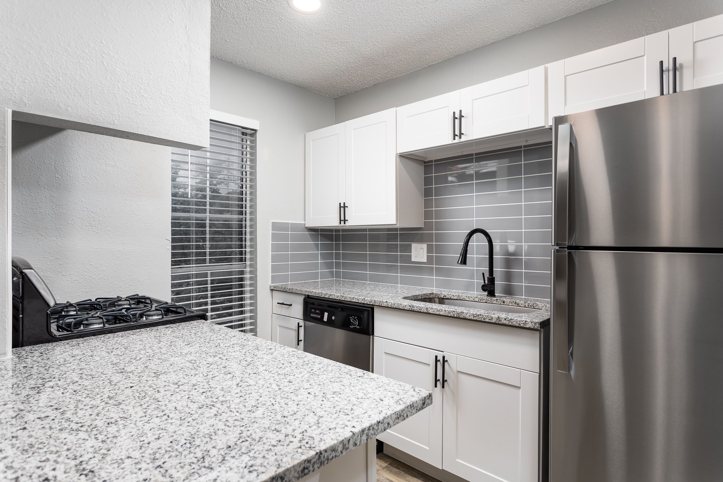 a kitchen with a sink and a refrigerator