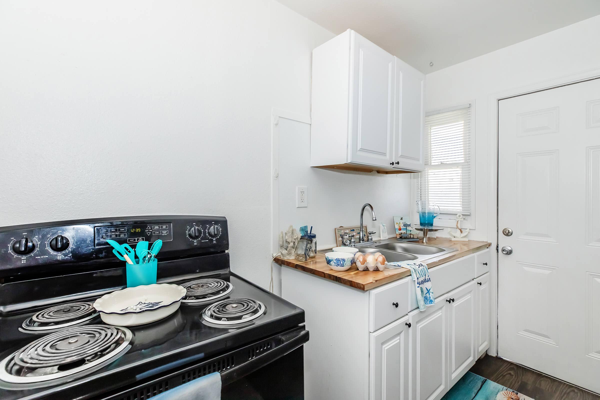 a stove top oven sitting inside of a kitchen