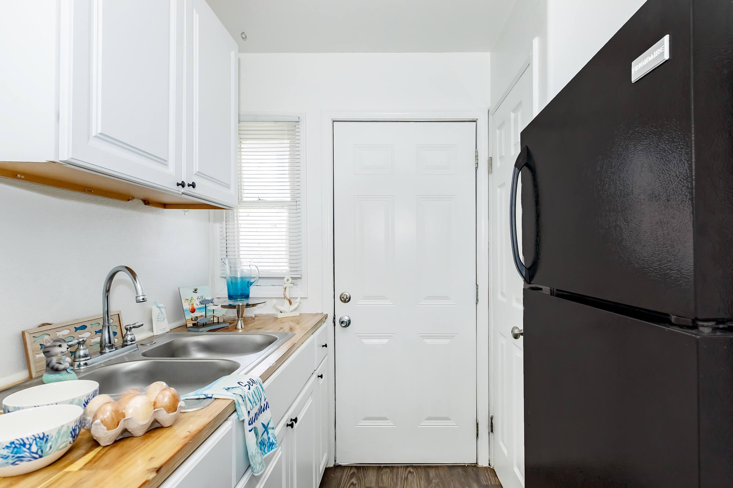 a kitchen with a sink and a refrigerator