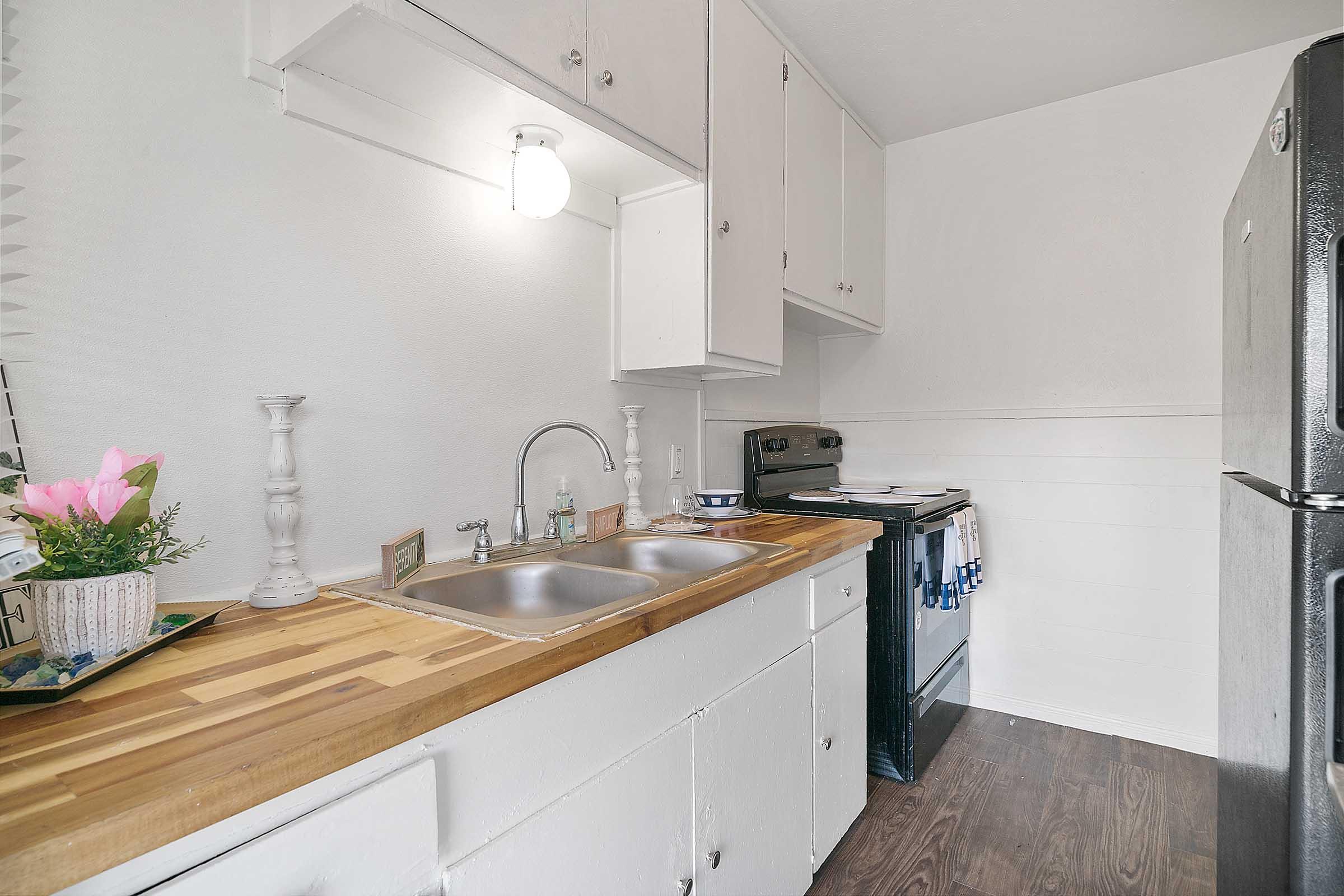 a kitchen with a sink and a refrigerator