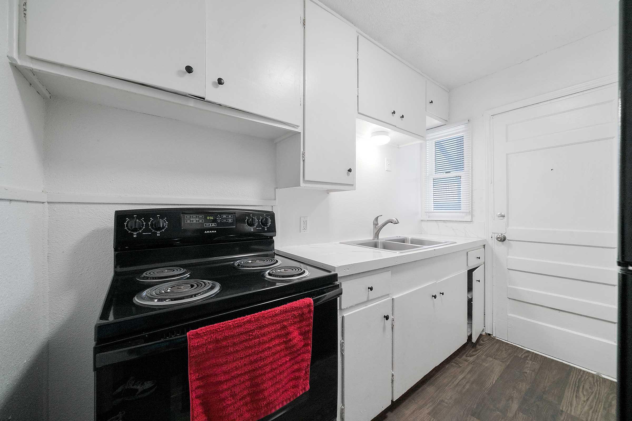 a stove top oven sitting inside of a kitchen