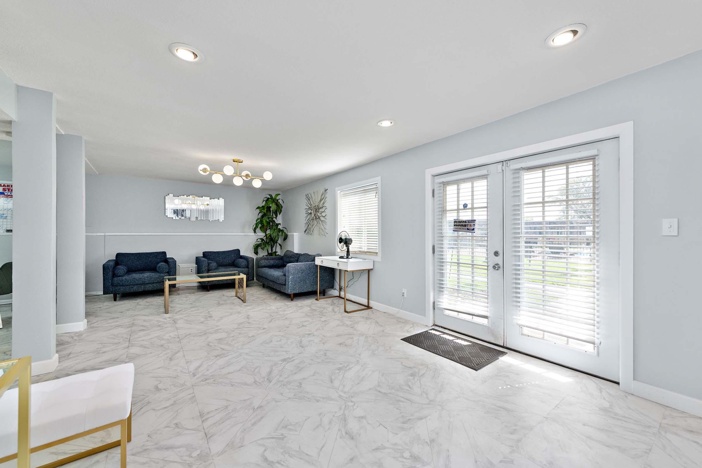 a living room filled with furniture and a large window