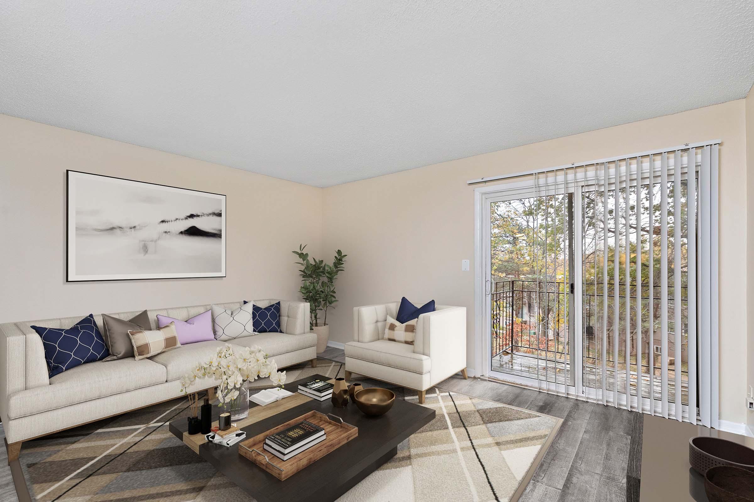 a living room filled with furniture and a large window