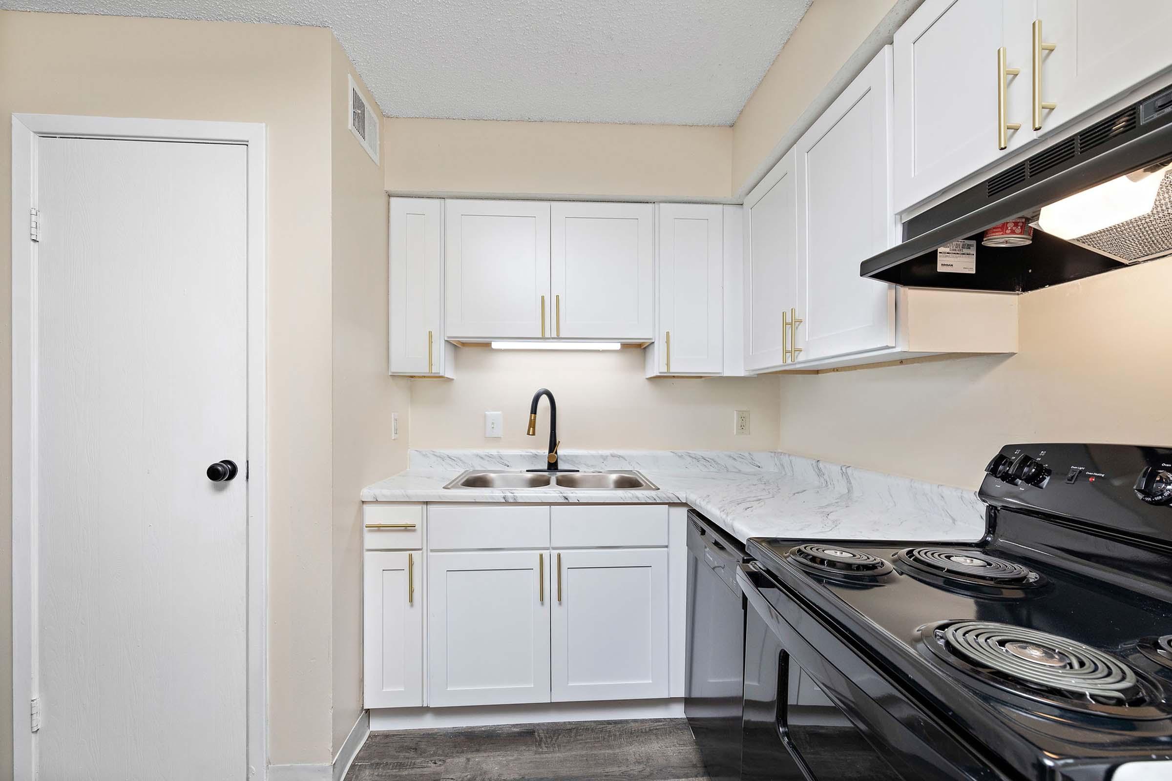 a stove top oven sitting inside of a kitchen