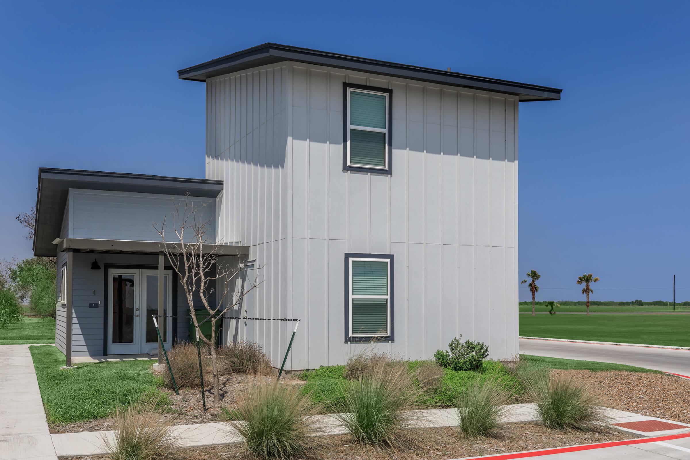 a house with a lawn in front of a building