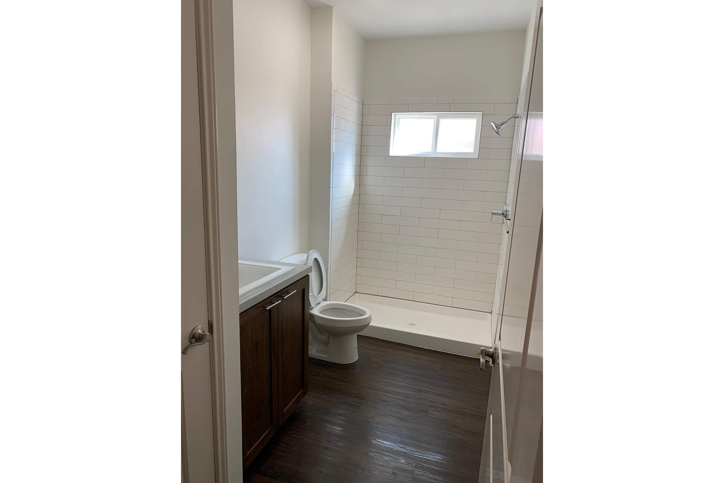 a white sink sitting under a window