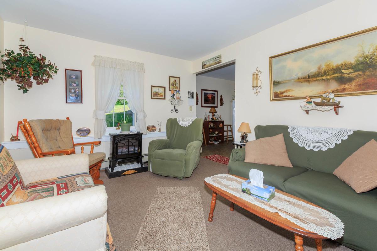 a living room filled with furniture and a flat screen tv