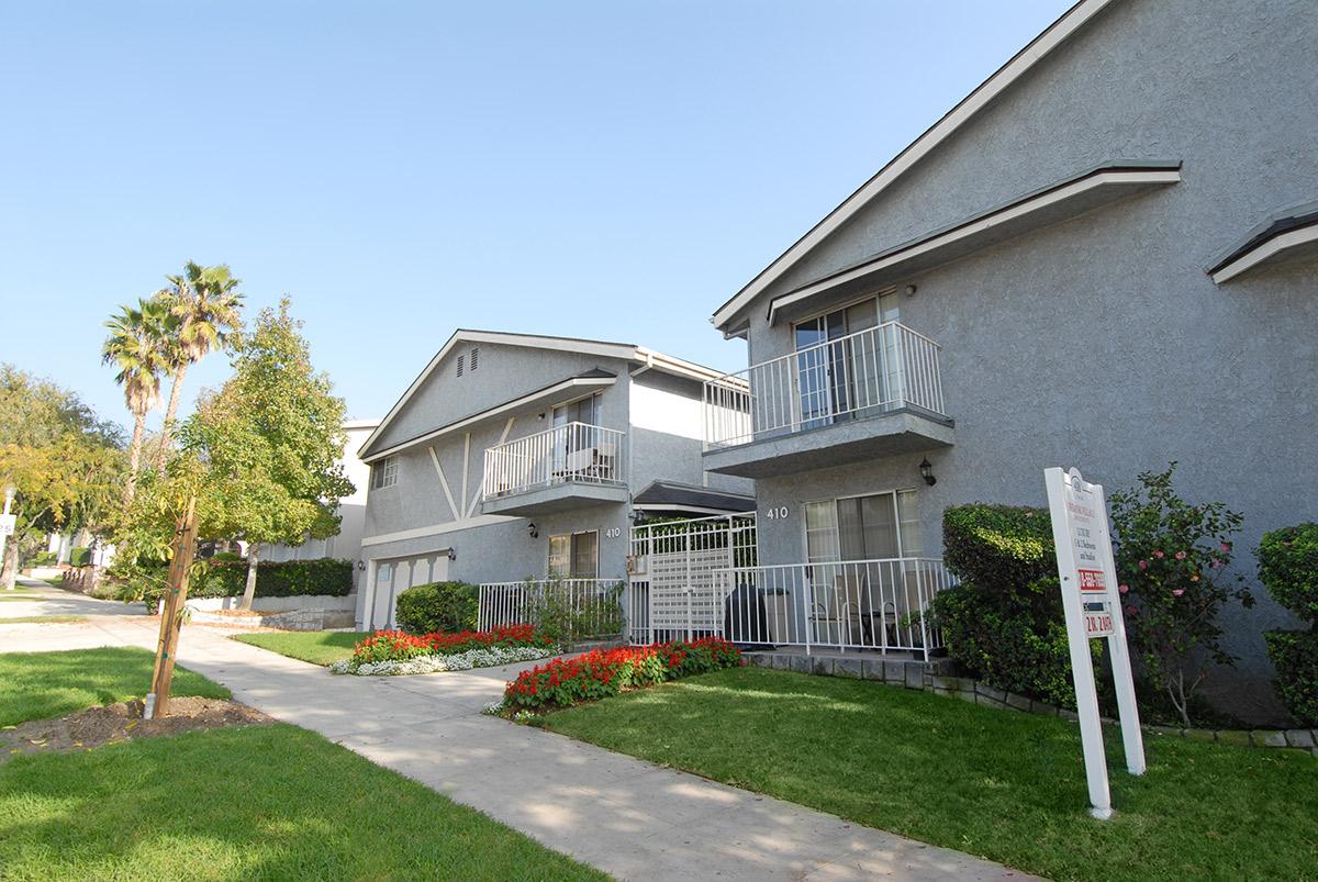 a house with a lawn in front of a building