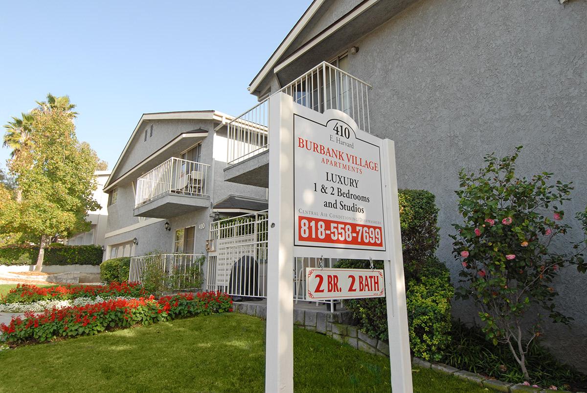 a sign in front of a house