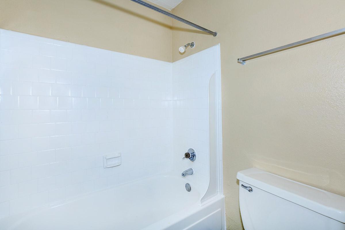 a white tub sitting next to a shower