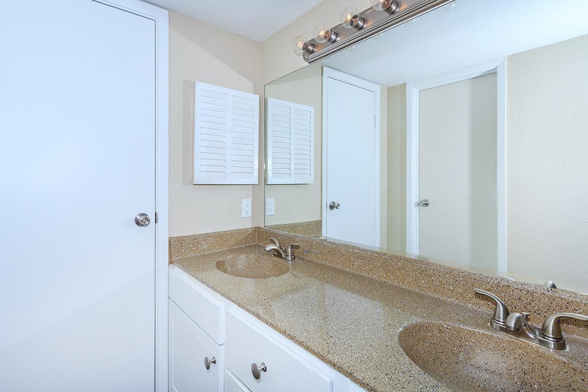 a room with a sink and a mirror