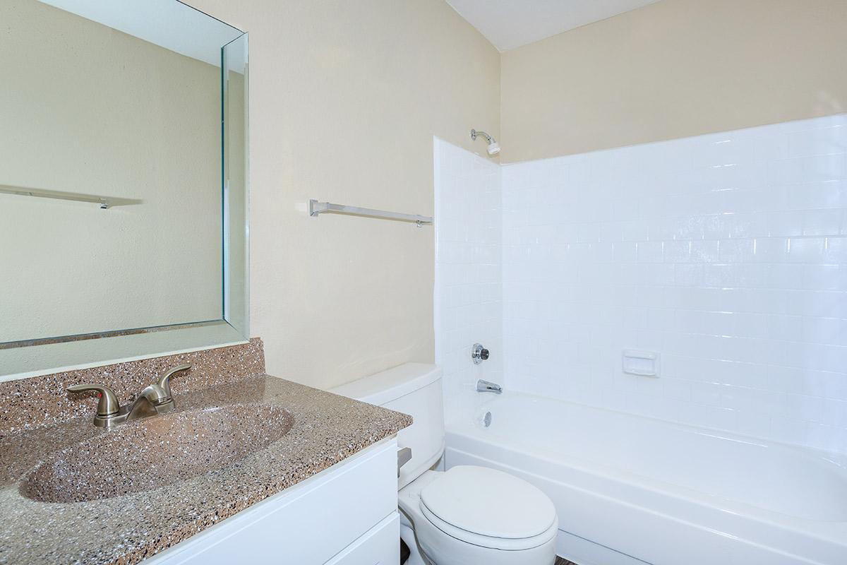 a large white tub next to a sink