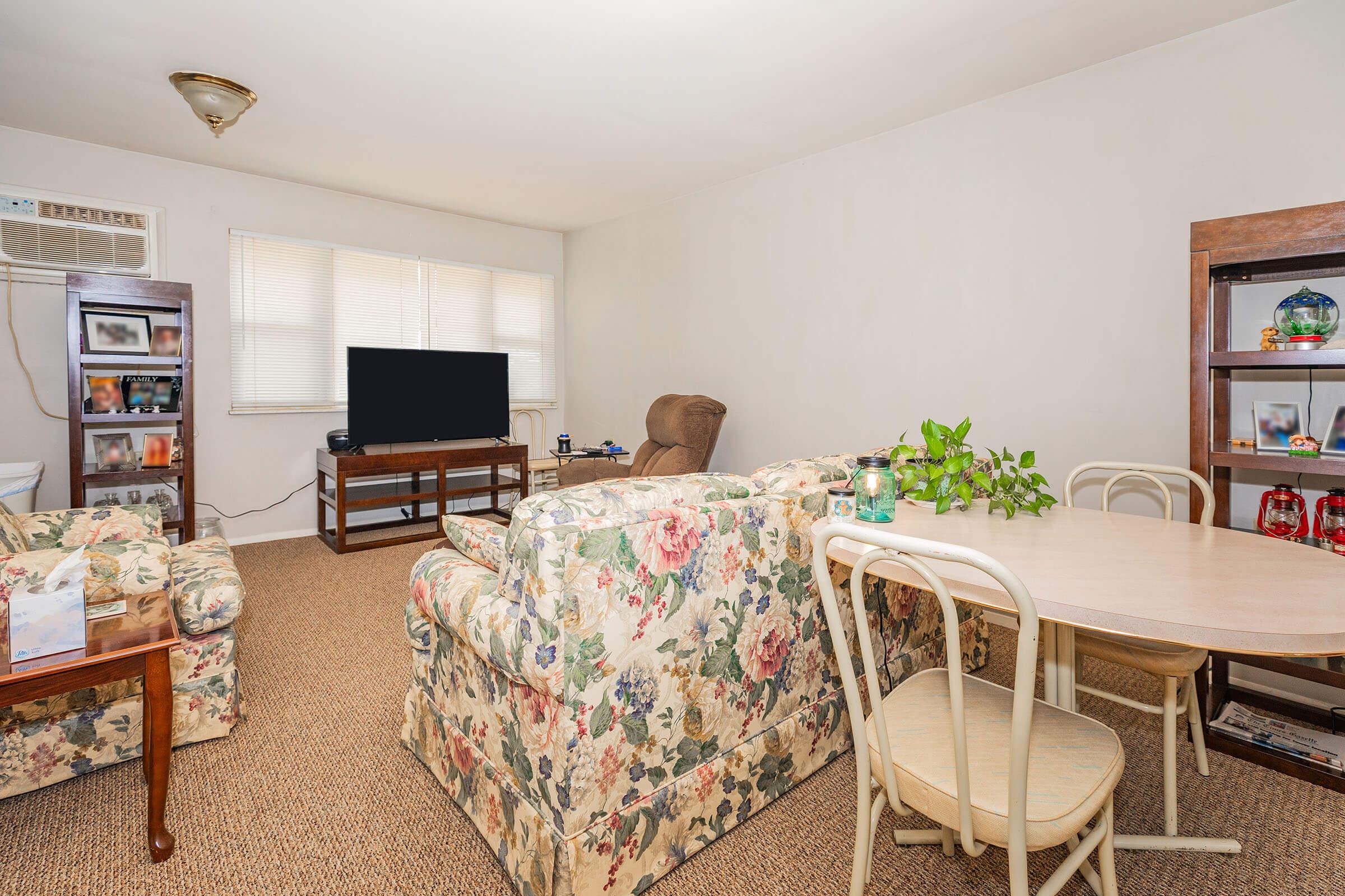 a living room filled with furniture and a tv